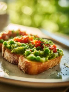 Fresh pea bruschetta topped with herbs and feta cheese on toasted bread