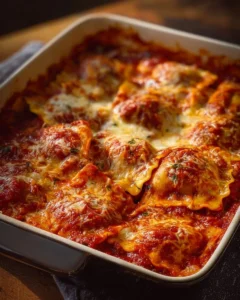 Baked ravioli dish with three simple ingredients, topped with cheese and herbs.