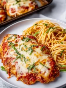 Delicious Baked Chicken Parmesan dish topped with marinara and cheese