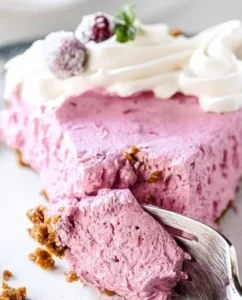 Delicious cranberry mousse pie topped with whipped cream and fresh cranberries