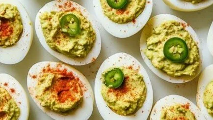 Mexican deviled eggs topped with spices and herbs