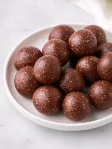 Delicious no bake date brownie bites served on a plate.