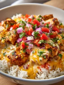 One-Pot Cheesy Southwest Chicken & Rice topped with melted cheese and herbs